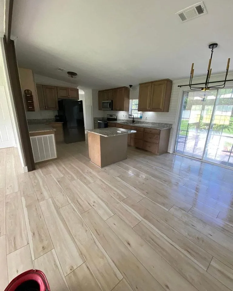 Clean open-concept kitchen with sparkling floors
