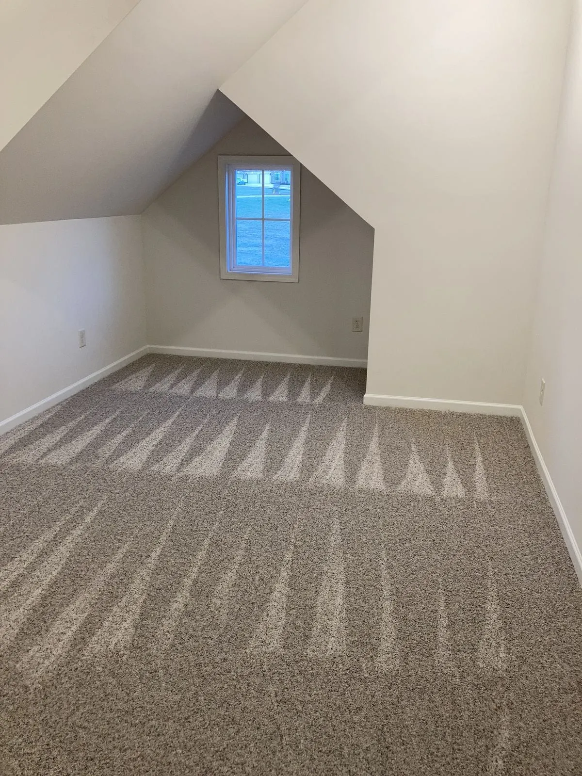 Freshly vacuumed carpet in a tidy upstairs bedroom
