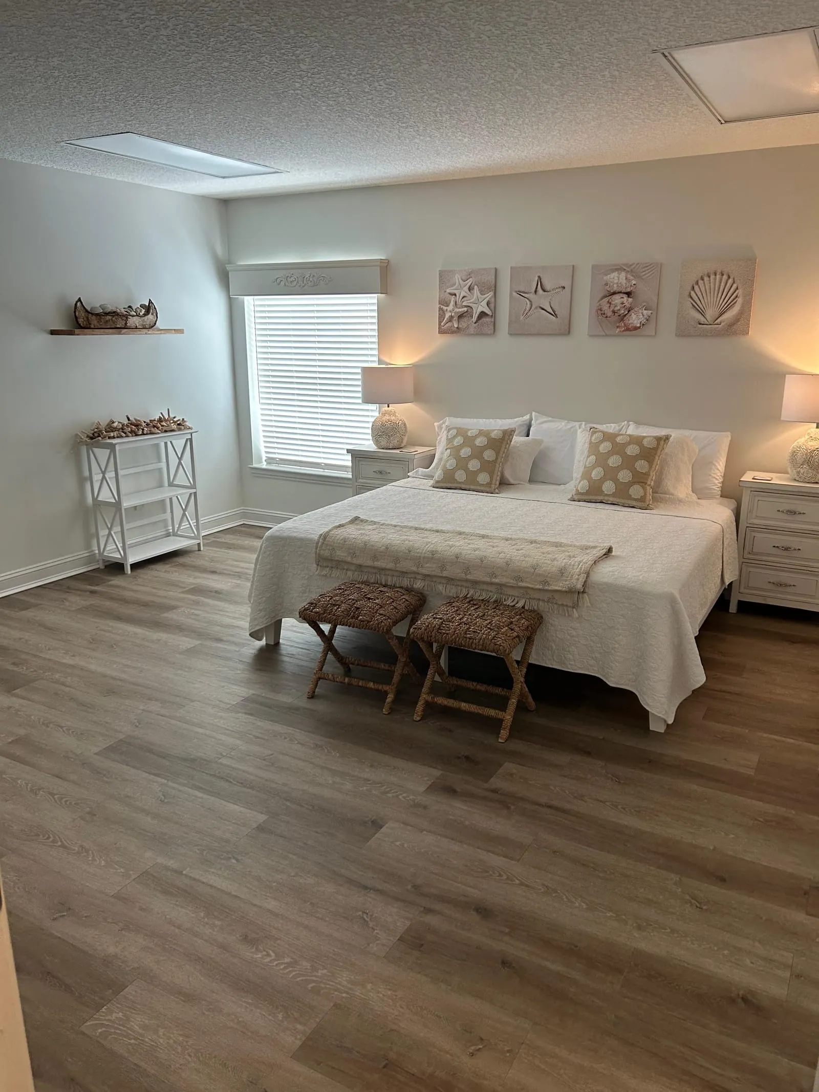 Bright, freshly made bedroom with coastal-style decor