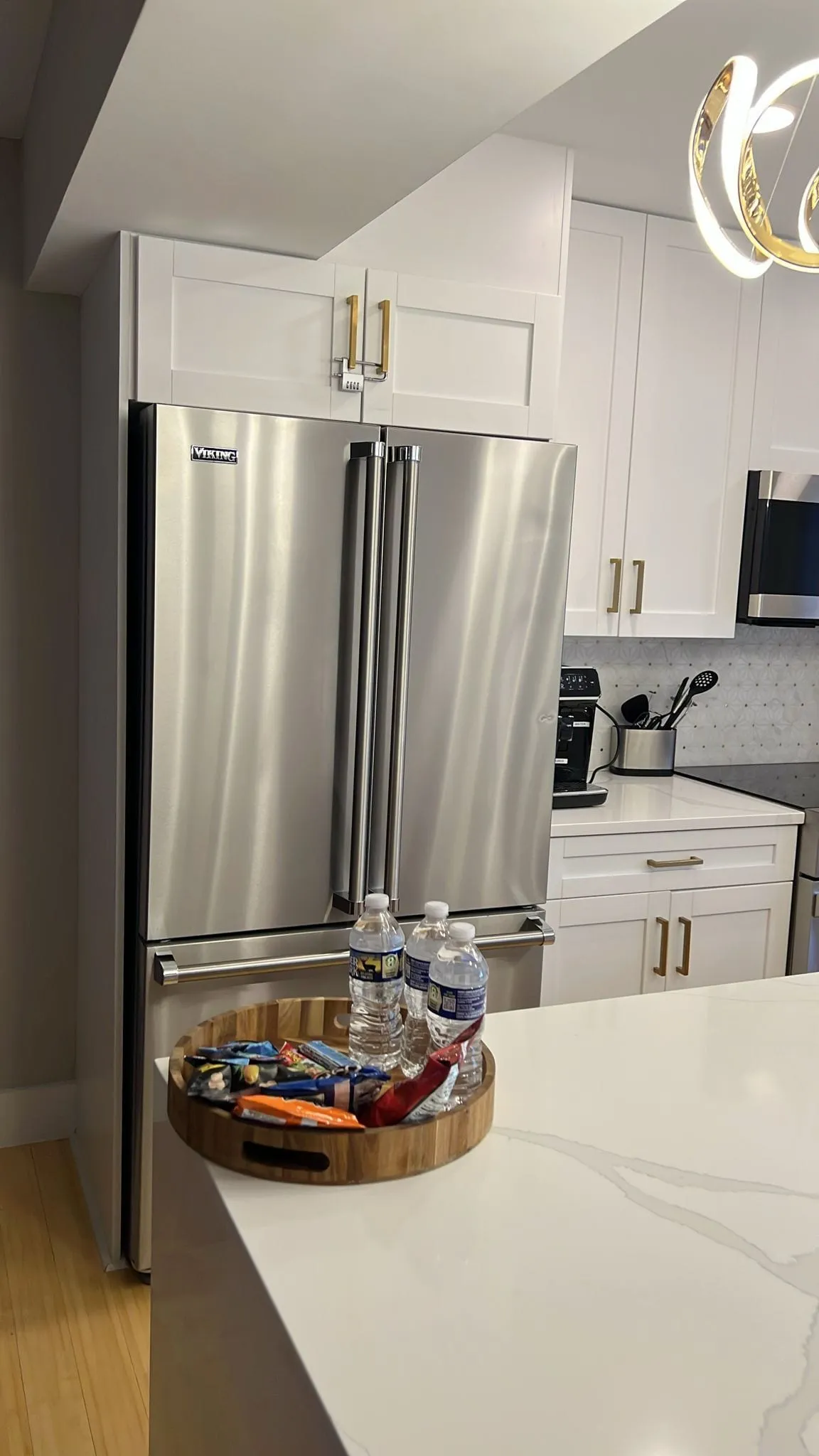 Sparkling stainless steel refrigerator and clean kitchen island