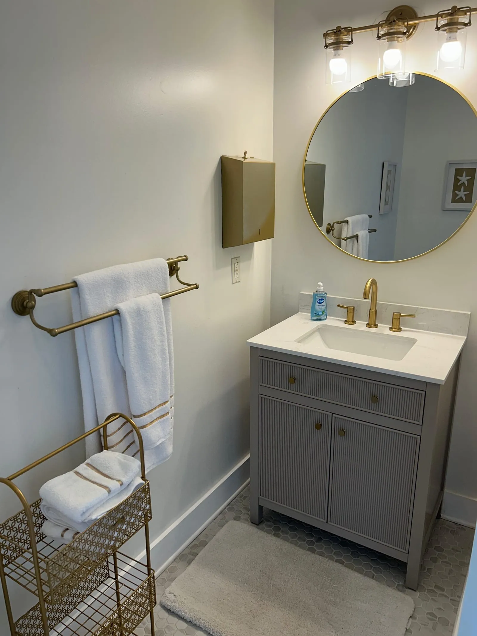 Clean bathroom vanity with polished mirror and fixtures